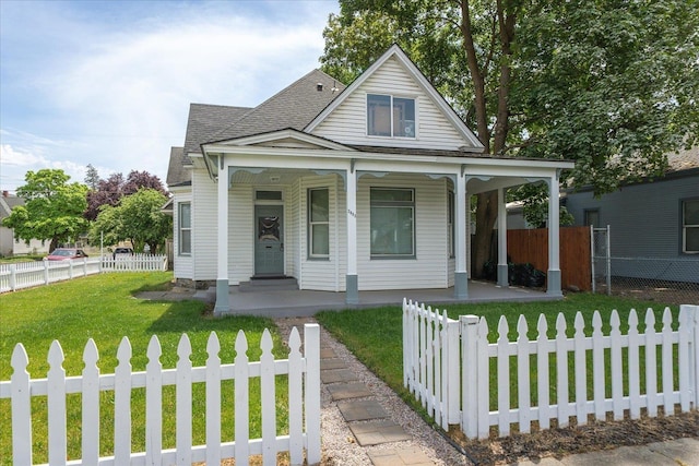 2003 W Mallon Ave, Spokane, WA 99201 - view of front of property with covered porch, roof with shingles, and a fenced front yard