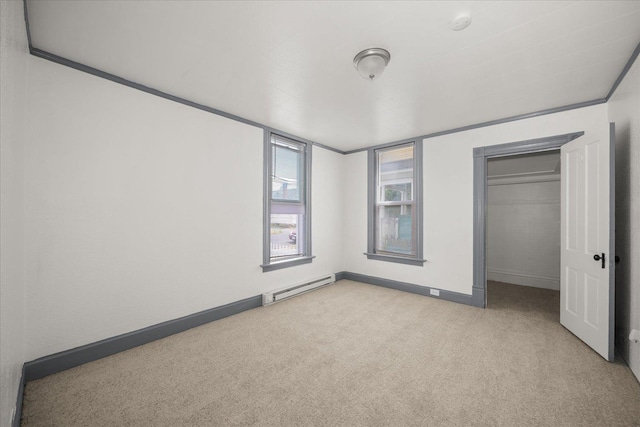 2003 W Mallon Ave, Spokane, WA 99201 - unfurnished bedroom featuring a baseboard radiator, light carpet, and a closet