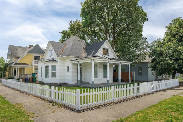 2003 W Mallon Ave, Spokane, WA 99201 - view of front facade featuring covered porch, a shingled roof, and a fenced front yard
