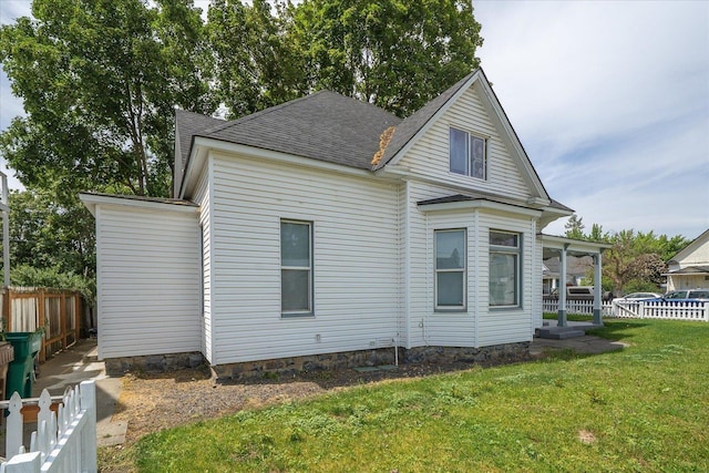 2003 W Mallon Ave, Spokane, WA 99201 - view of side of home featuring a fenced backyard and a shingled roof