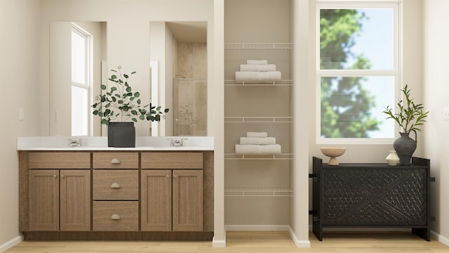 24812 E Hawkstone Loop, Liberty Lake, WA 99019 - full bathroom featuring double vanity and wood finished floors