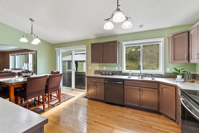 5981 Blackstone Way, Nine Mile Falls, WA 99026 - kitchen with stainless steel dishwasher, plenty of natural light, a chandelier, hanging light fixtures, and vaulted ceiling