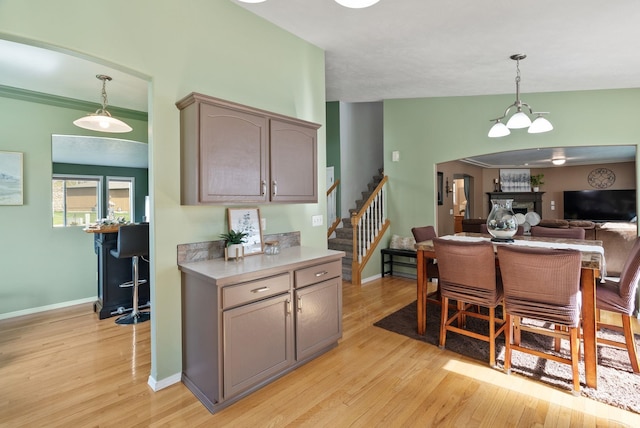 5981 Blackstone Way, Nine Mile Falls, WA 99026 - kitchen with light wood finished floors, light countertops, pendant lighting, a chandelier, and open floor plan