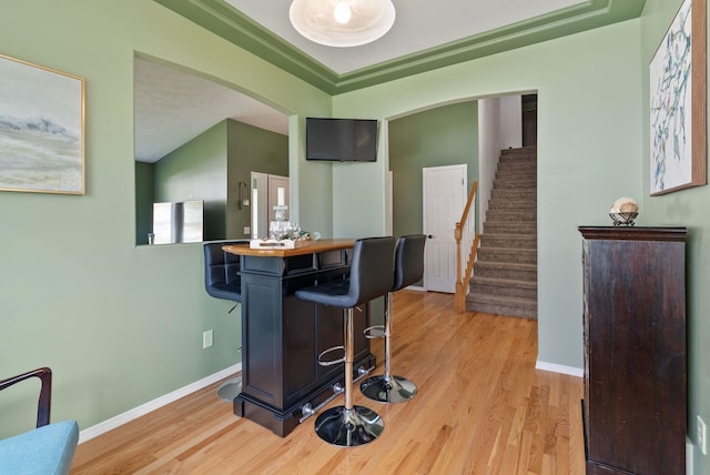 5981 Blackstone Way, Nine Mile Falls, WA 99026 - bar area with arched walkways, light wood finished floors, and stairway