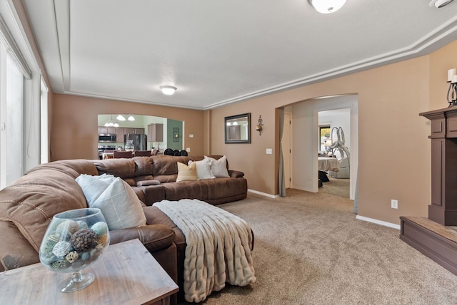 5981 Blackstone Way, Nine Mile Falls, WA 99026 - living room with arched walkways, light carpet, and healthy amount of natural light