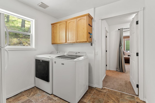 5981 Blackstone Way, Nine Mile Falls, WA 99026 - washroom featuring washer and clothes dryer, cabinet space, and stone finish flooring