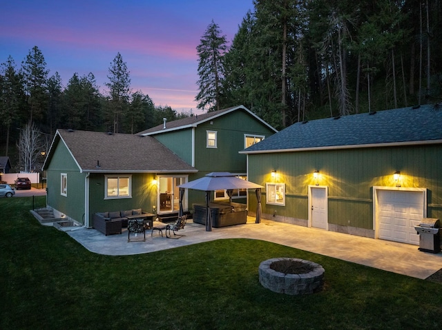 5981 Blackstone Way, Nine Mile Falls, WA 99026 - back of house at dusk featuring an outdoor living space with a fire pit, a gazebo, a yard, and a patio
