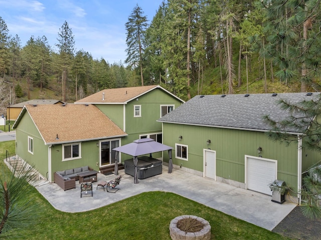 5981 Blackstone Way, Nine Mile Falls, WA 99026 - rear view of house featuring a hot tub, a shingled roof, outdoor lounge area, a yard, and a patio area