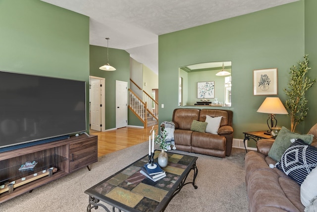 5981 Blackstone Way, Nine Mile Falls, WA 99026 - living area with vaulted ceiling, carpet floors, and stairs