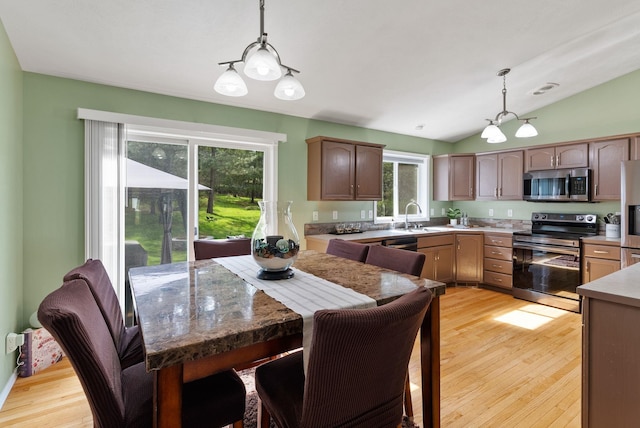 5981 Blackstone Way, Nine Mile Falls, WA 99026 - kitchen with appliances with stainless steel finishes, light wood finished floors, lofted ceiling, pendant lighting, and light countertops