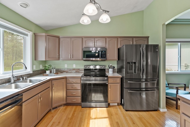 5981 Blackstone Way, Nine Mile Falls, WA 99026 - kitchen featuring appliances with stainless steel finishes, vaulted ceiling, light wood-style flooring, light countertops, and decorative light fixtures