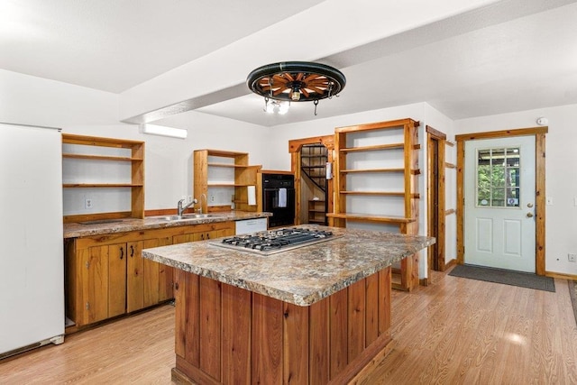 491 Winterfield Rd, Newport, WA 99156 - kitchen featuring open shelves, stainless steel gas cooktop, light wood-type flooring, brown cabinetry, and freestanding refrigerator