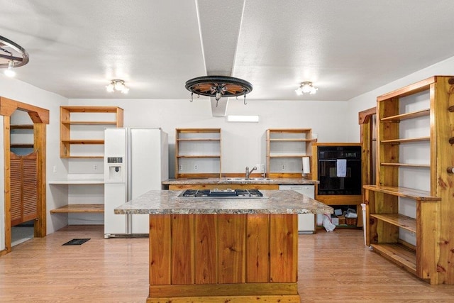 491 Winterfield Rd, Newport, WA 99156 - kitchen featuring open shelves, white appliances, light wood-type flooring, and a kitchen island