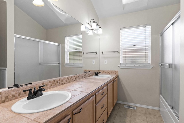 1707 N Harmony Ln, Greenacres, WA 99016 - full bath with double vanity, vaulted ceiling, decorative backsplash, tile patterned floors, and a chandelier