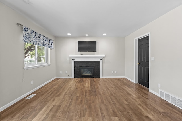 1707 N Harmony Ln, Greenacres, WA 99016 - unfurnished living room featuring a tiled fireplace, wood finished floors, and recessed lighting