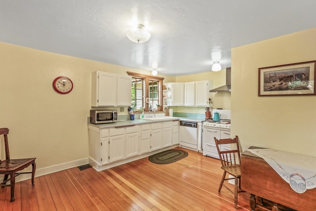 11 E Camden Rd, Elk, WA 99009 - kitchen with white appliances, wall chimney range hood, white cabinetry, light countertops, and light wood-style flooring