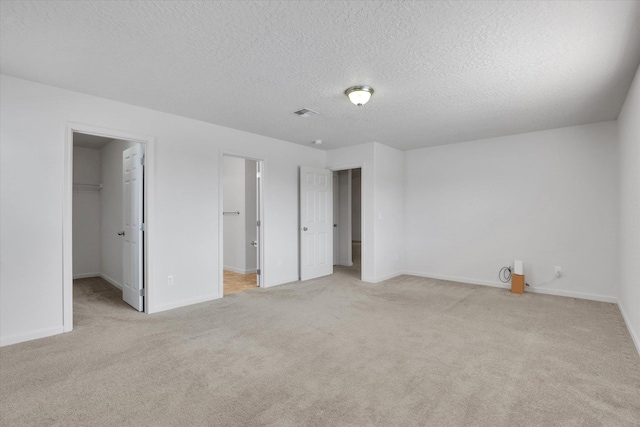 7316 S Dour St, Cheney, WA 99004 - unfurnished bedroom featuring carpet, a textured ceiling, a spacious closet, and a closet