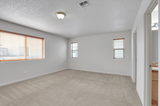 7316 S Dour St, Cheney, WA 99004 - empty room with light carpet and a textured ceiling