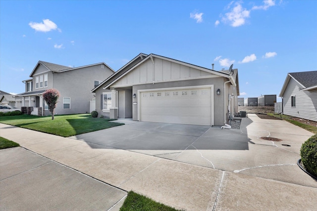 7316 S Dour St, Cheney, WA 99004 - view of front of house featuring board and batten siding, an attached garage, concrete driveway, and a front yard
