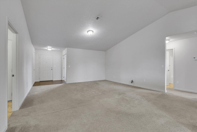 7316 S Dour St, Cheney, WA 99004 - spare room featuring light colored carpet, lofted ceiling, and a textured ceiling
