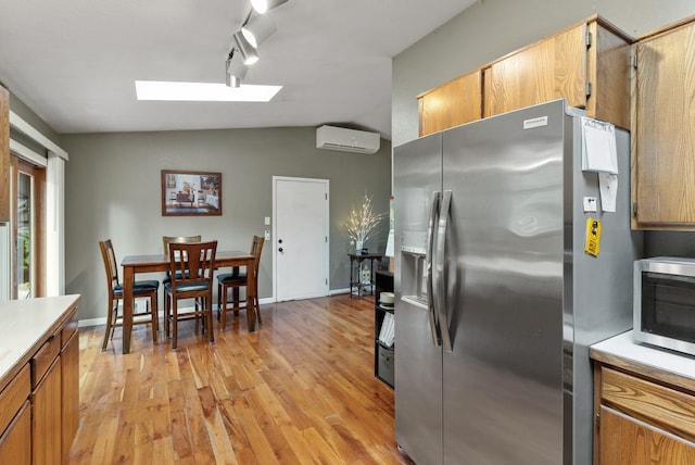 15007 W Willynwood Ln, Nine Mile Falls, WA 99026 - kitchen with stainless steel appliances, light wood finished floors, a skylight, light countertops, and track lighting