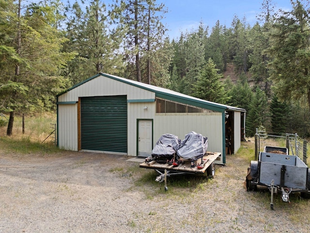 15007 W Willynwood Ln, Nine Mile Falls, WA 99026 - detached garage with dirt driveway and a view of trees