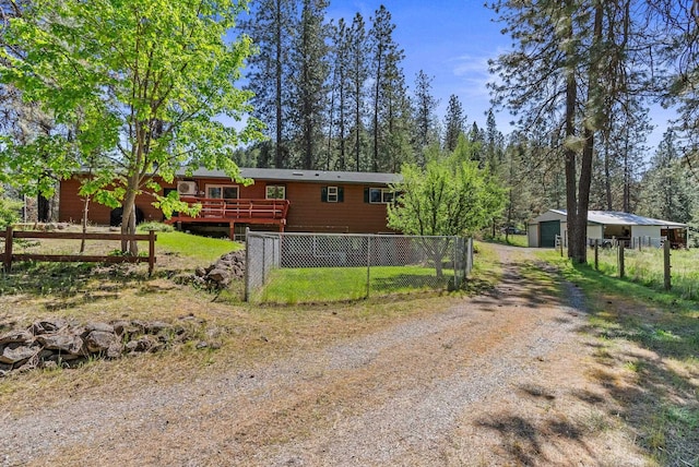 15007 W Willynwood Ln, Nine Mile Falls, WA 99026 - view of front of property featuring dirt driveway, a deck, and a garage
