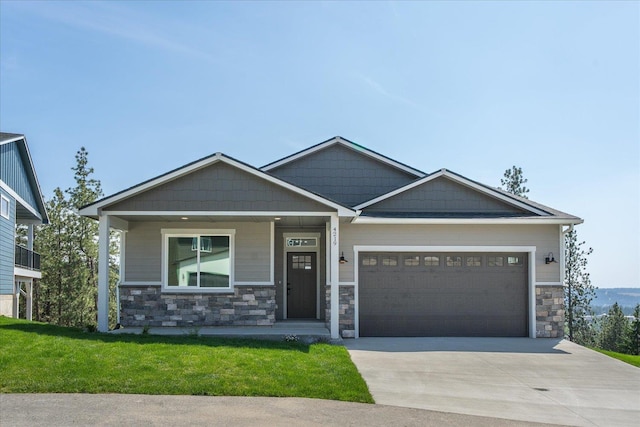 4219 W Tolliver Ct, Spokane, WA 99208 - craftsman-style house featuring stone siding, concrete driveway, an attached garage, a front yard, and covered porch