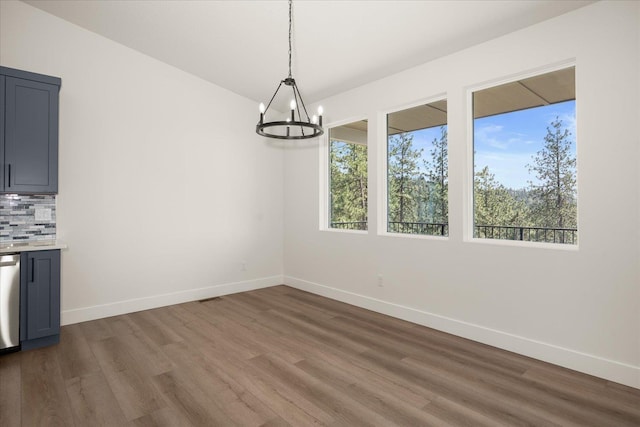 4219 W Tolliver Ct, Spokane, WA 99208 - unfurnished dining area with wood finished floors and a chandelier