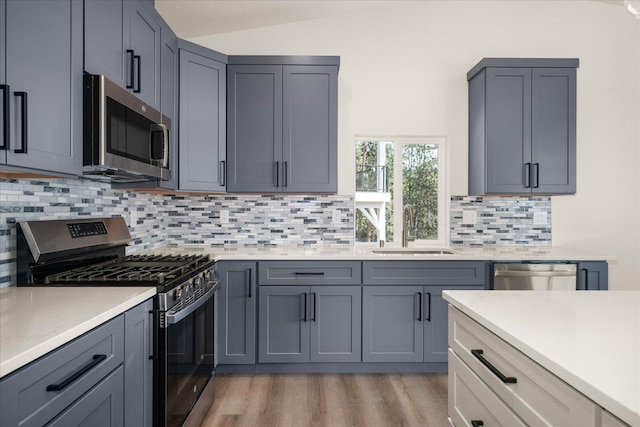 4219 W Tolliver Ct, Spokane, WA 99208 - kitchen featuring appliances with stainless steel finishes, light countertops, light wood finished floors, and tasteful backsplash