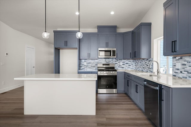 4219 W Tolliver Ct, Spokane, WA 99208 - kitchen with stainless steel appliances, a kitchen island, decorative backsplash, dark wood-type flooring, and recessed lighting