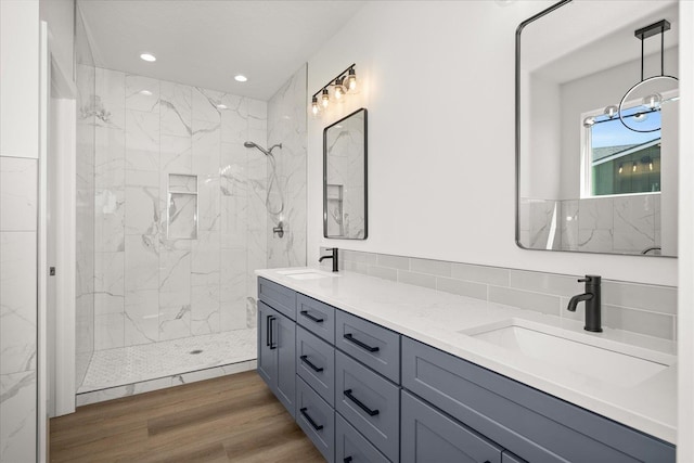 4219 W Tolliver Ct, Spokane, WA 99208 - full bath with double vanity, a marble finish shower, wood finished floors, and recessed lighting