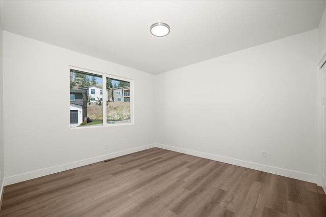4219 W Tolliver Ct, Spokane, WA 99208 - spare room featuring wood finished floors and baseboards