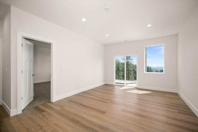 4219 W Tolliver Ct, Spokane, WA 99208 - empty room with light wood-style floors, recessed lighting, and a smoke detector