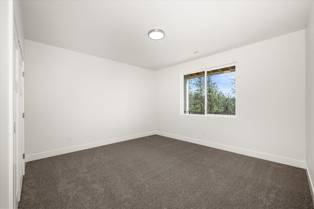 4219 W Tolliver Ct, Spokane, WA 99208 - spare room with baseboards and dark colored carpet