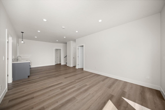4219 W Tolliver Ct, Spokane, WA 99208 - unfurnished living room featuring recessed lighting and wood finished floors