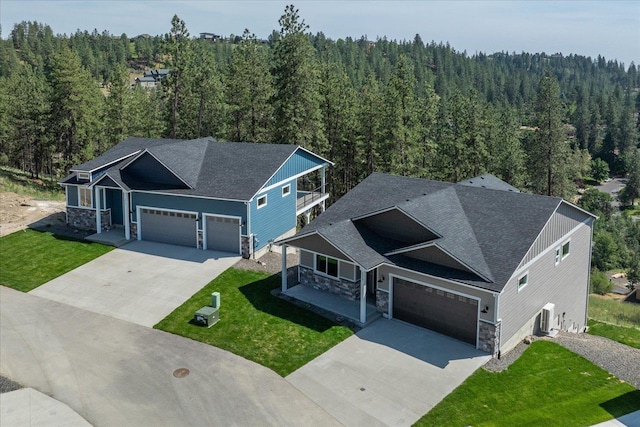 4219 W Tolliver Ct, Spokane, WA 99208 - view of front of home featuring stone siding and a view of trees