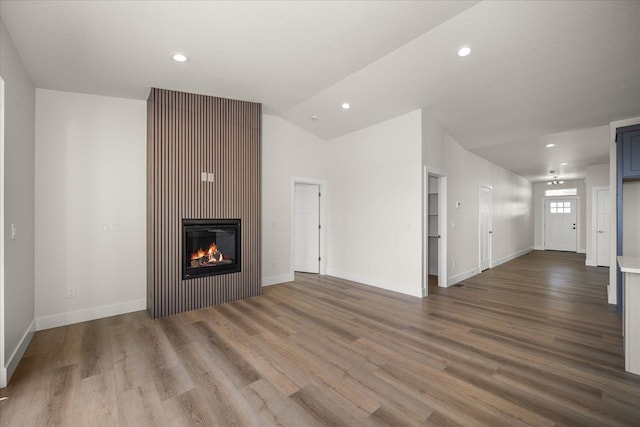 4219 W Tolliver Ct, Spokane, WA 99208 - unfurnished living room with a glass covered fireplace, wood finished floors, lofted ceiling, and recessed lighting