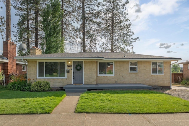 5615 N Forest Blvd, Spokane, WA 99205 - ranch-style home featuring a front lawn, brick siding, and a chimney