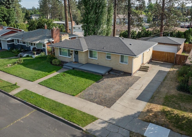 5615 N Forest Blvd, Spokane, WA 99205 - ranch-style house with a detached garage, roof with shingles, an outdoor structure, brick siding, and a chimney