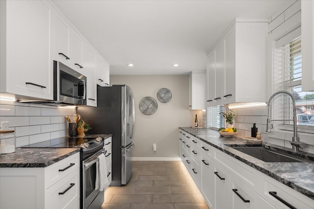 5615 N Forest Blvd, Spokane, WA 99205 - kitchen with appliances with stainless steel finishes, recessed lighting, backsplash, white cabinets, and tile patterned flooring