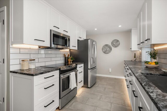 5615 N Forest Blvd, Spokane, WA 99205 - kitchen with stainless steel appliances, recessed lighting, backsplash, white cabinetry, and dark stone counters
