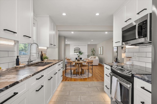 5615 N Forest Blvd, Spokane, WA 99205 - kitchen featuring stainless steel appliances, dark stone countertops, backsplash, white cabinetry, and recessed lighting