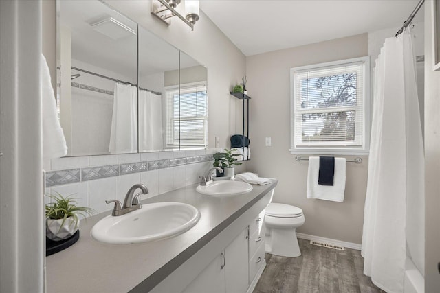 5615 N Forest Blvd, Spokane, WA 99205 - full bath featuring decorative backsplash, double vanity, wood finished floors, and a shower with curtain