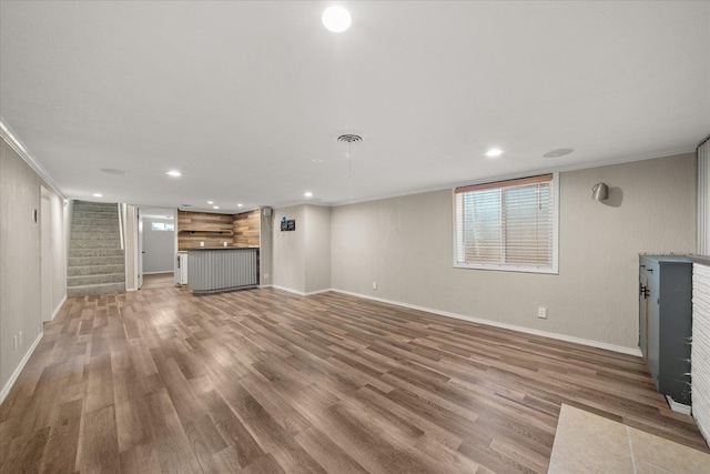 5615 N Forest Blvd, Spokane, WA 99205 - unfurnished living room with wood finished floors, ornamental molding, recessed lighting, stairs, and bar area