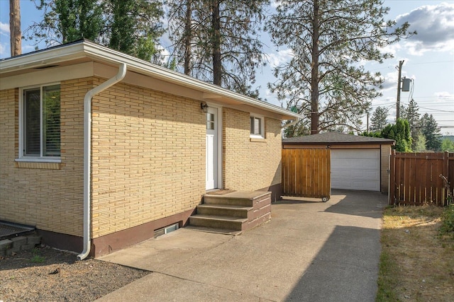 5615 N Forest Blvd, Spokane, WA 99205 - view of side of home with a garage, an outbuilding, entry steps, and brick siding