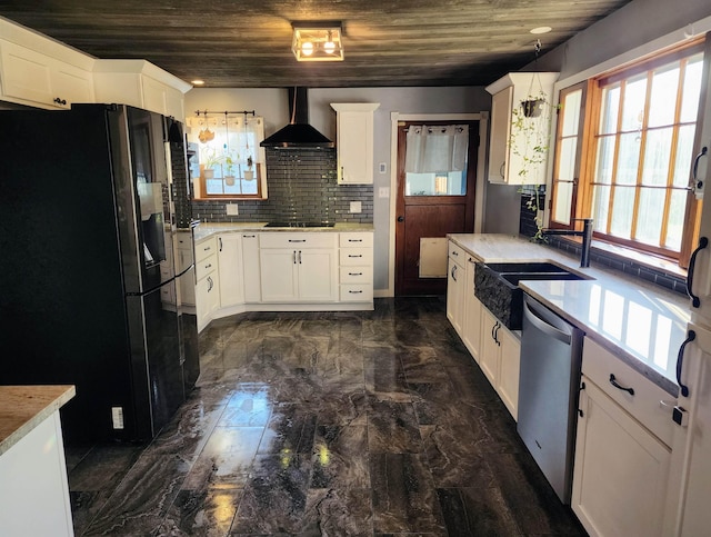 4107 N Bessie Rd, Spokane, WA 99212 - kitchen with black appliances, wall chimney range hood, dark marble finish flooring, white cabinetry, and light countertops