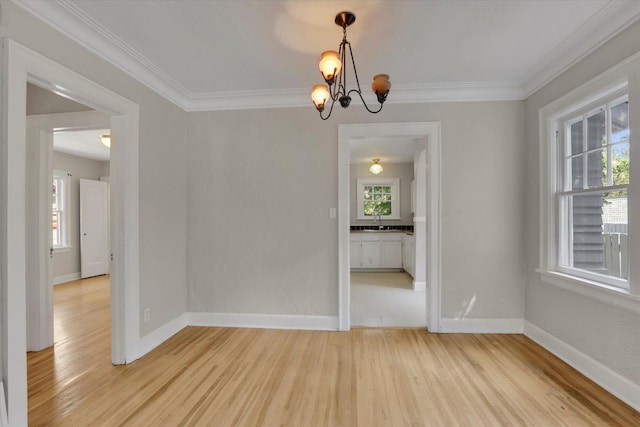 8 W 26th Ave, Spokane, WA 99203 - empty room with a chandelier, light wood-type flooring, and ornamental molding
