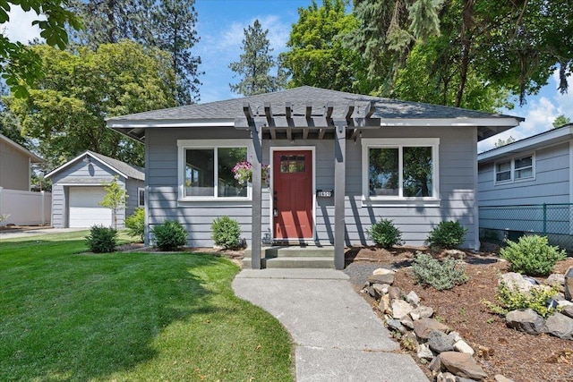 1409 E 36th Ave, Spokane, WA 99203 - bungalow with a detached garage, an outbuilding, and a shingled roof