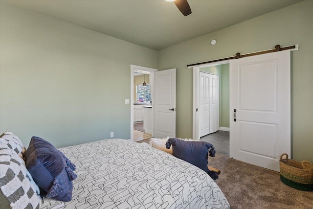 1409 E 36th Ave, Spokane, WA 99203 - carpeted bedroom featuring a barn door, a ceiling fan, and a closet